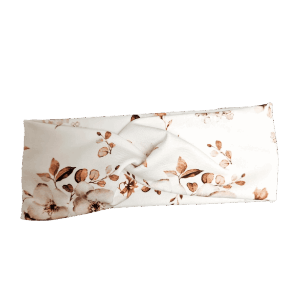 Witte haarband met bruine bloemenmotief en gedraaide stof in het midden